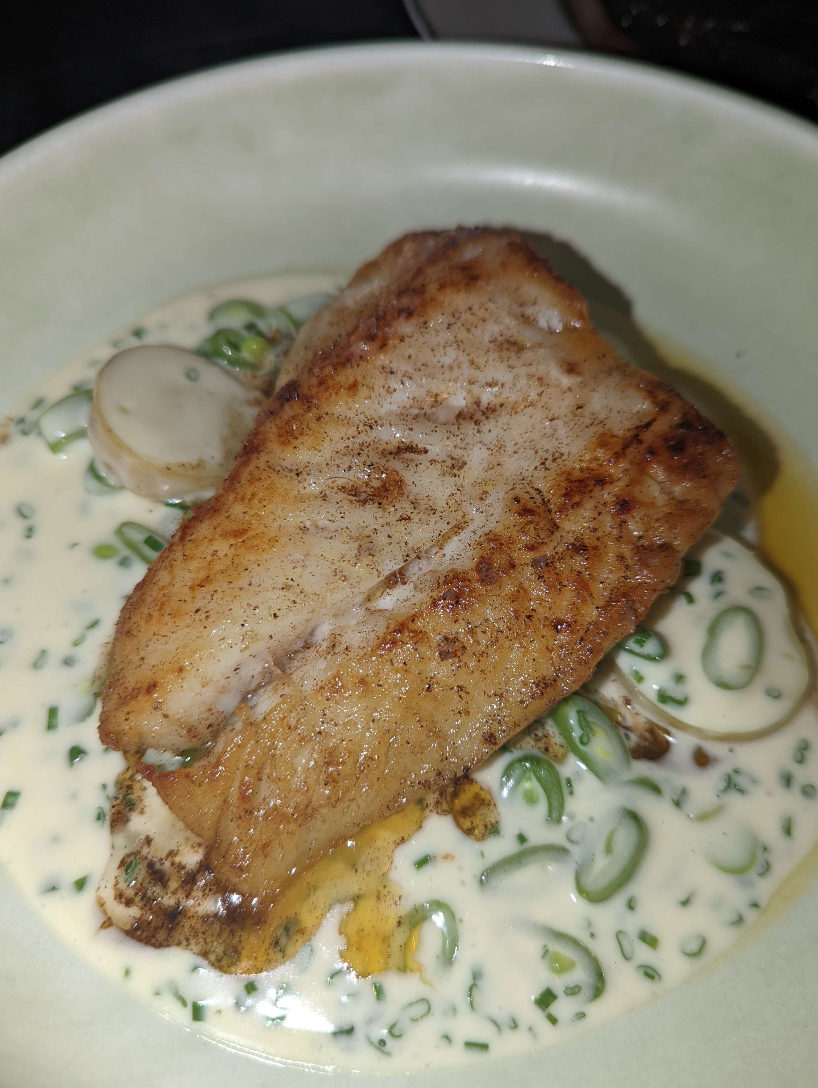A perfectly cooked fillet of salmon on a bed of potatoes, spring onions and creme fraiche. Taken during an evening at Nineteen at The Star.