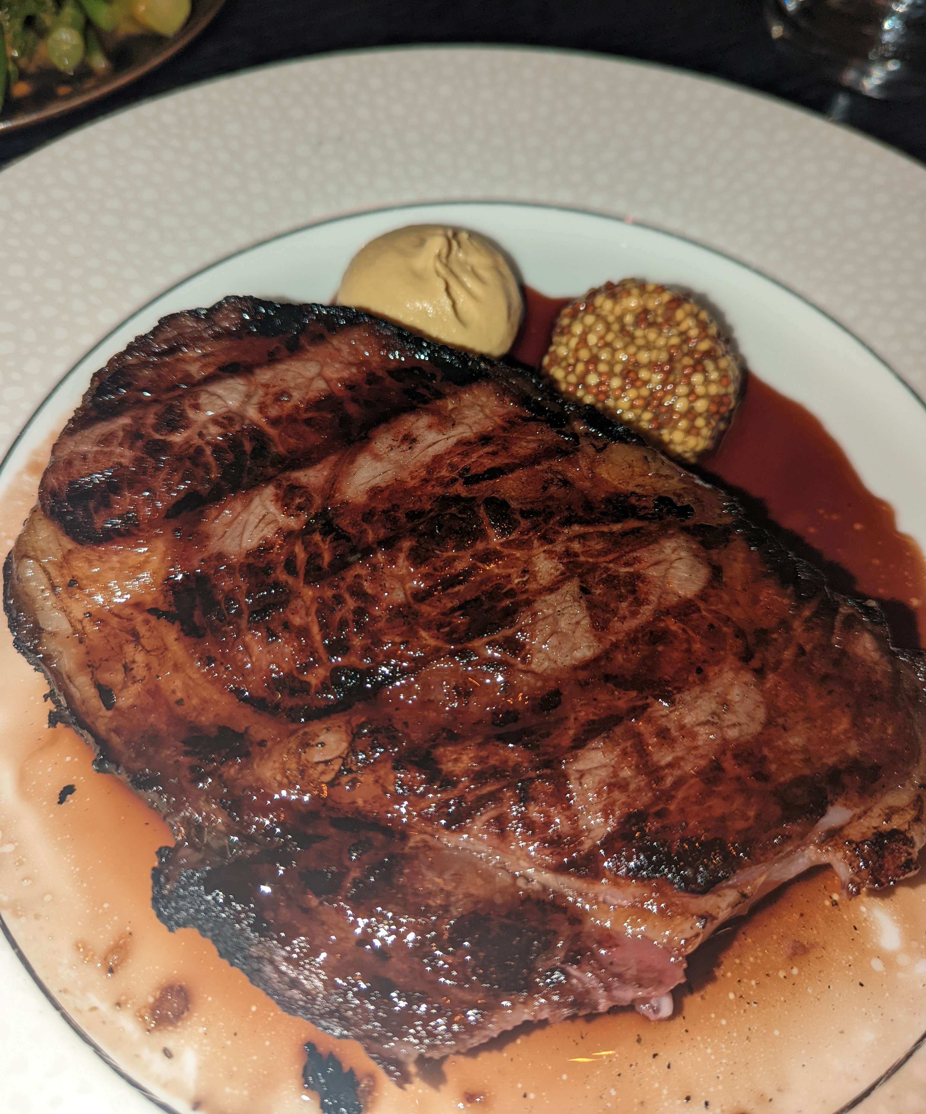 A perfectly grilled steak, drizzled with it's own juices and a side of two different types of mustards. Taken during an evening at Nineteen at The Star.