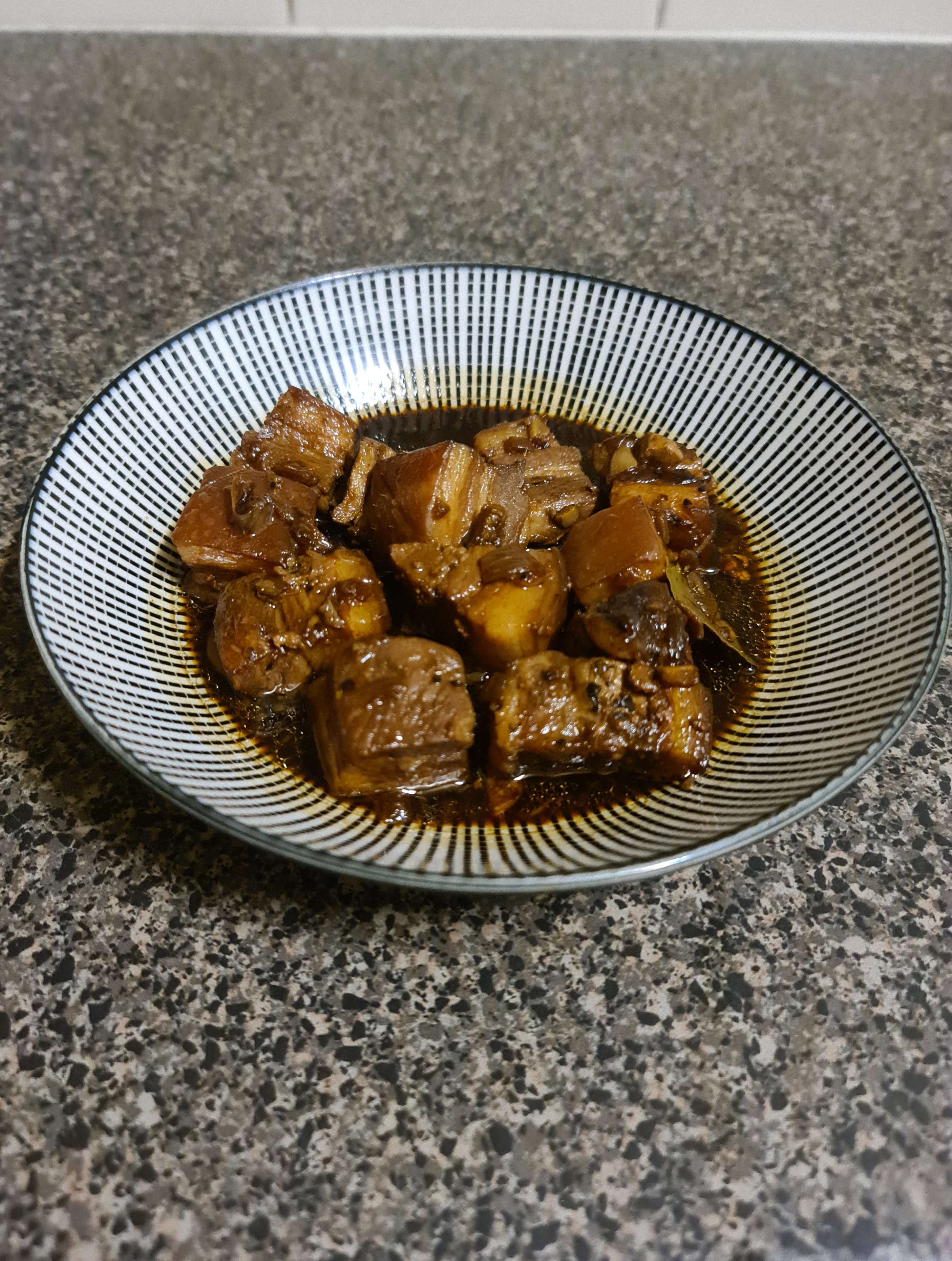 A photo of homemade pork adobo in a bowl.